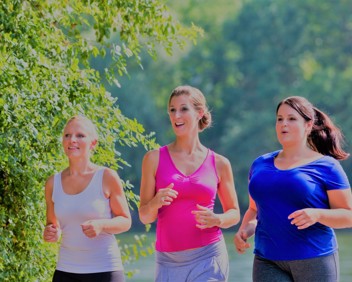 Group of women running at lakeside jogging